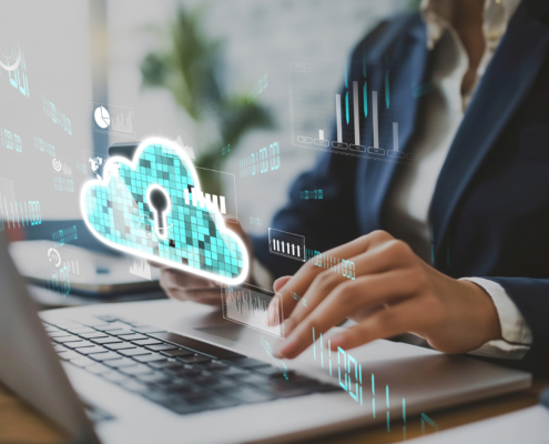 Side View Of Person Typing On Computer With Locked Cloud Storage Graphic Hovering Over Keyboard
