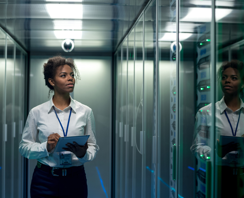 Front View Of Woman Walking In Data Center Or Server Room