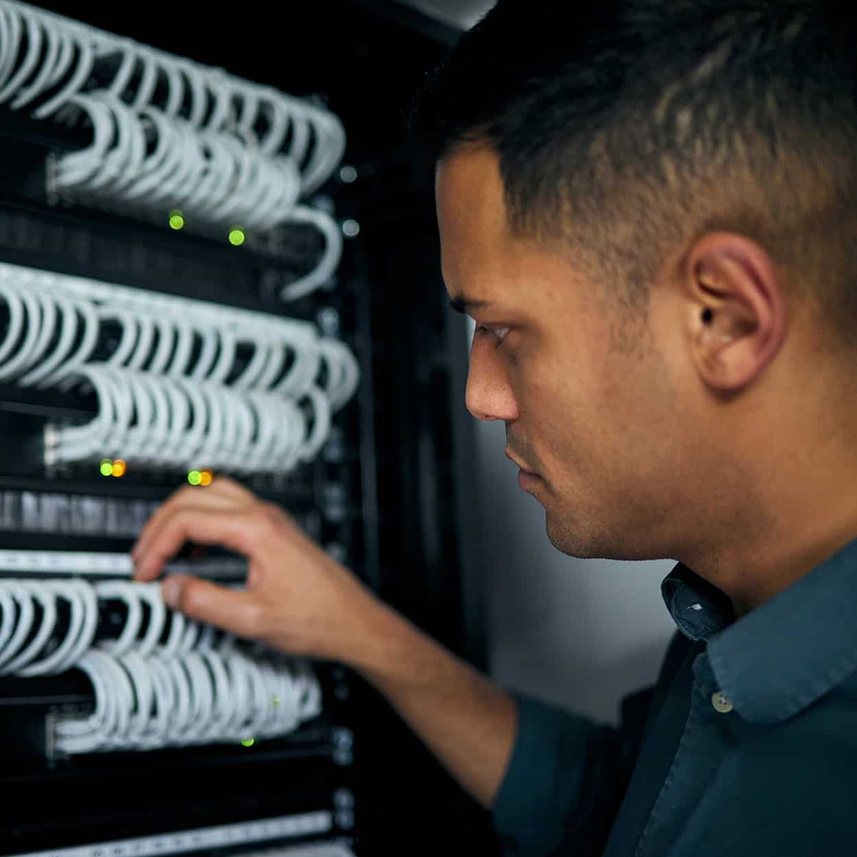 Header Side View Of A Man Looking At Wiring In A Server Room