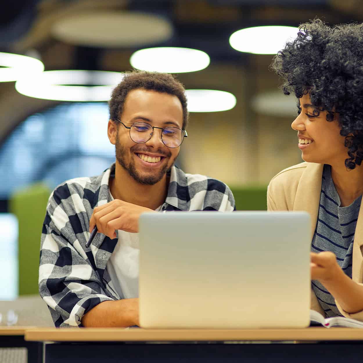 Header Two Smiling People Collaborating On Laptop