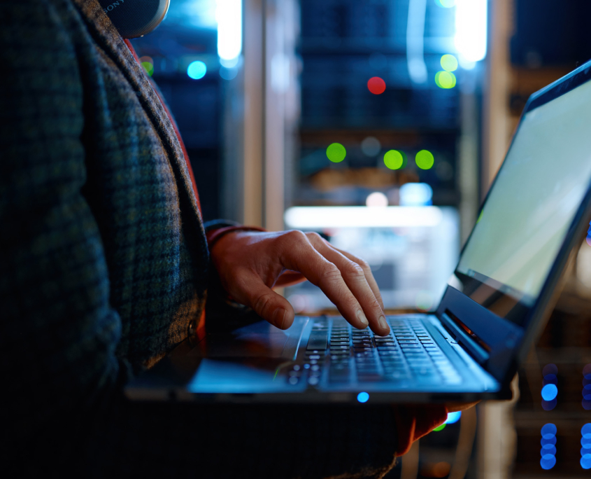 Side View Of Person On Laptop Computer