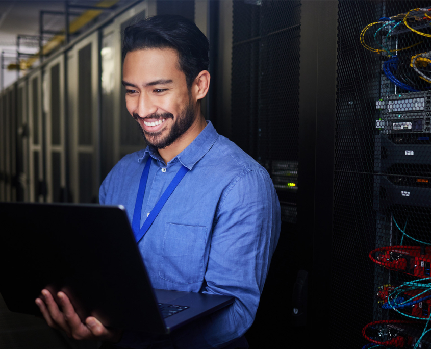 Front View Of Man On Laptop Computer Smiling