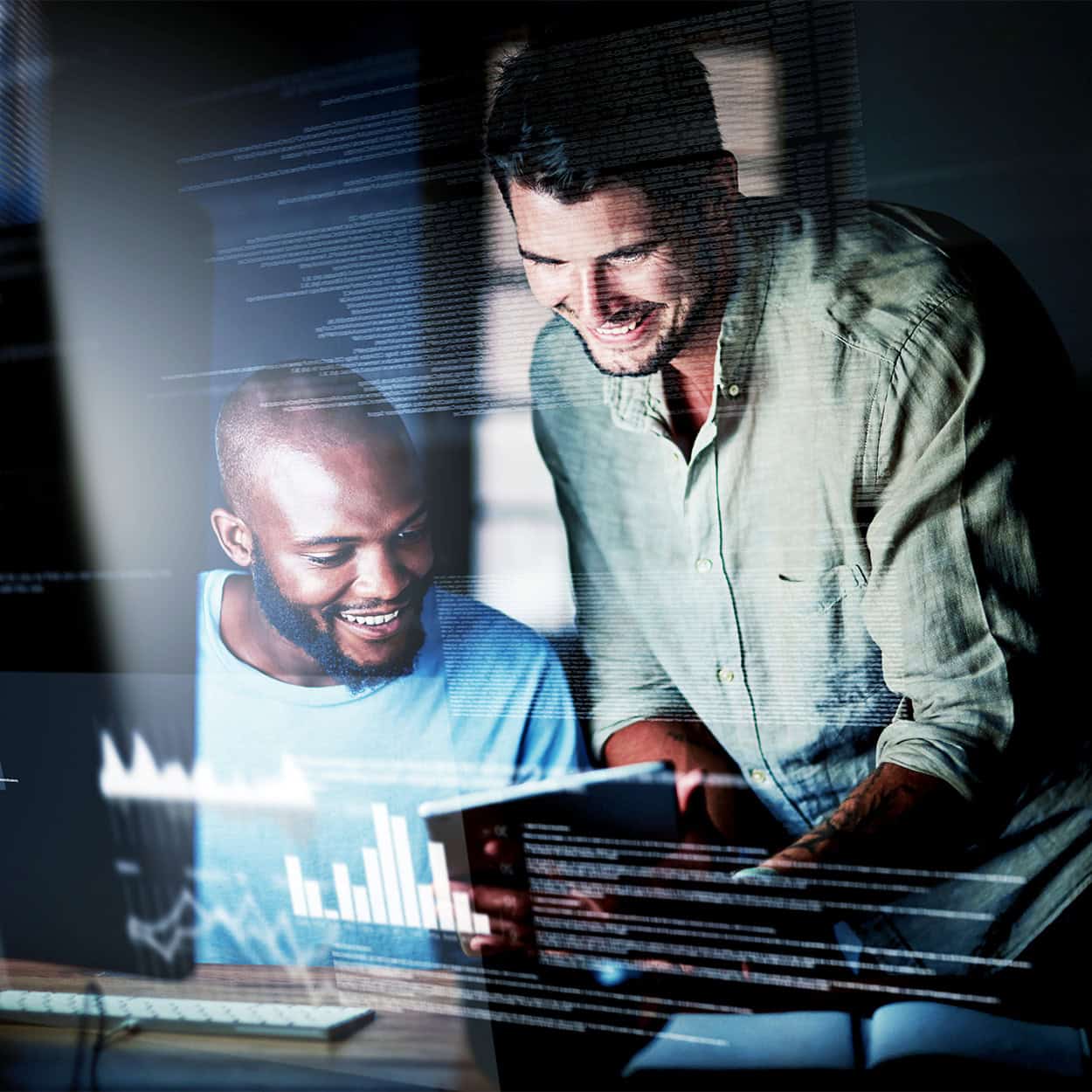 Header Front View Of Two Smiling Men Looking At Computer With Text Overlayed On Image