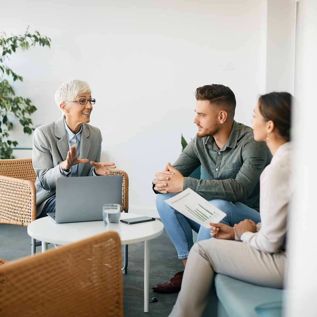 Header Happy Senior Financial Adviser Talks To Couple During The Meeting In Office