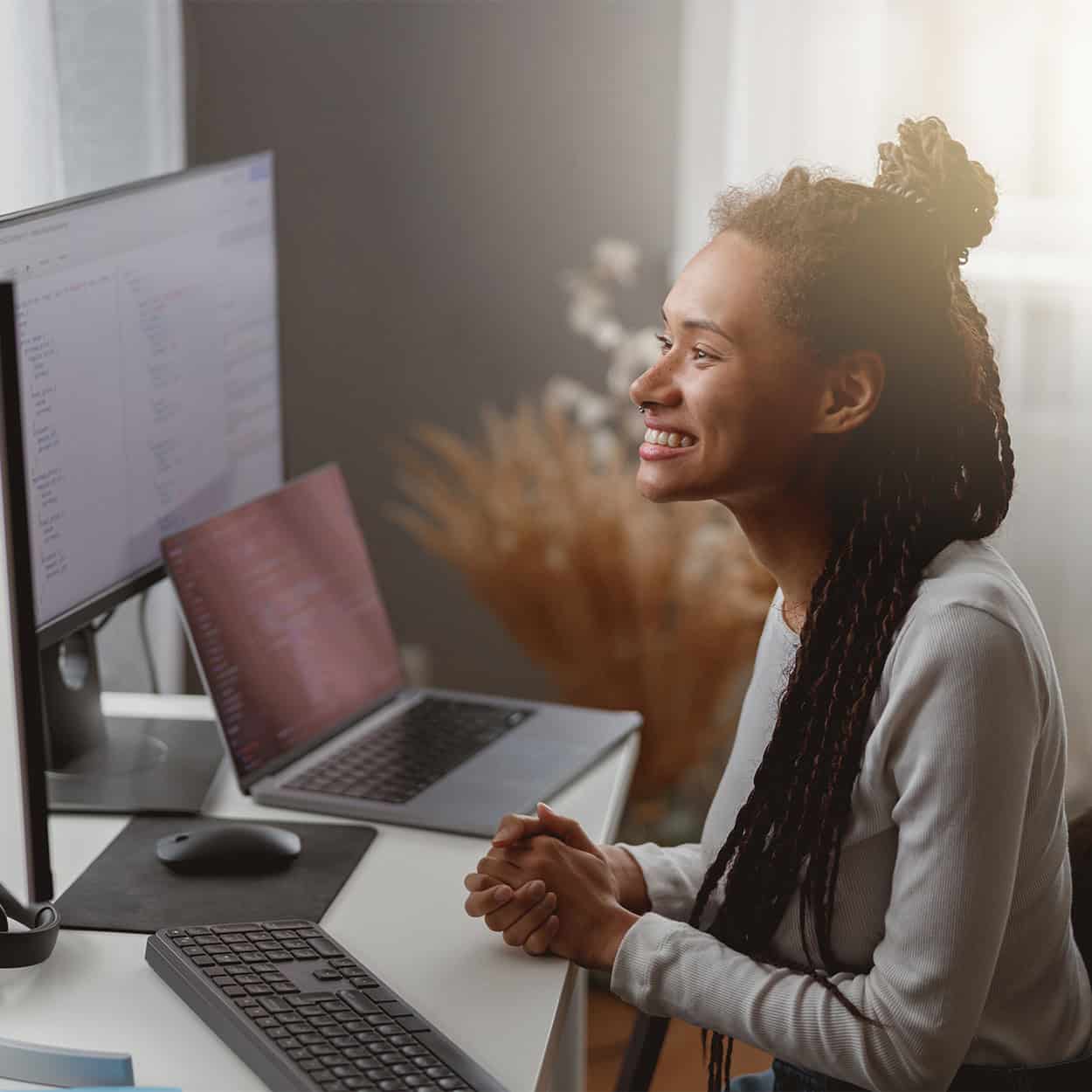 Header Side View Of Smiling Woman Looking At Computer Screen