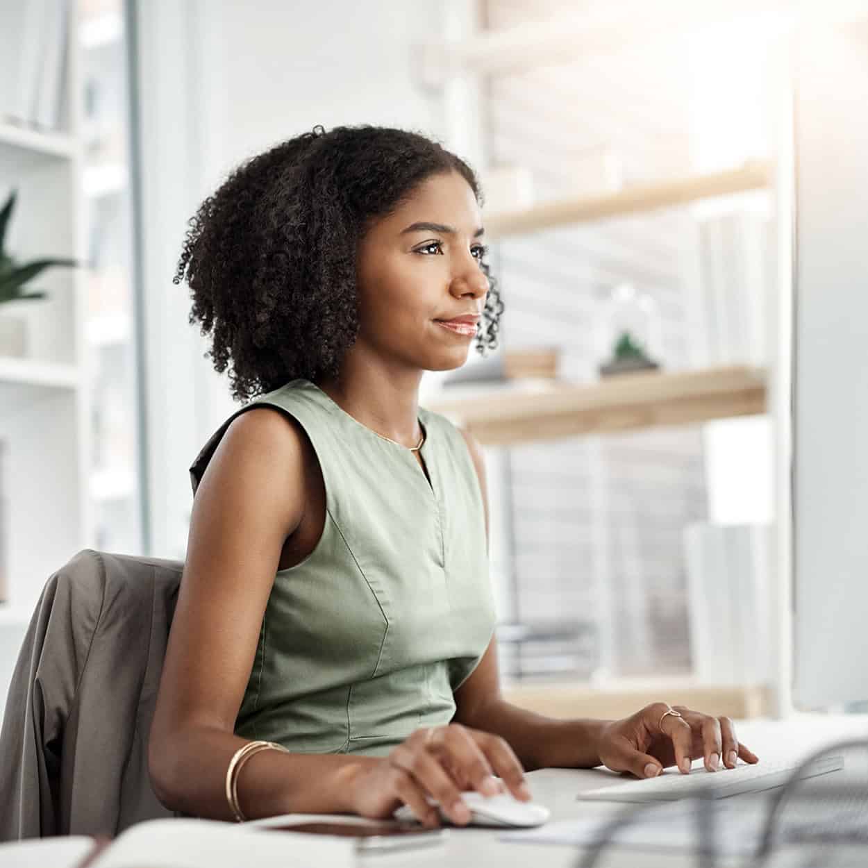 Header Side View Of Young Professional On Her Computer