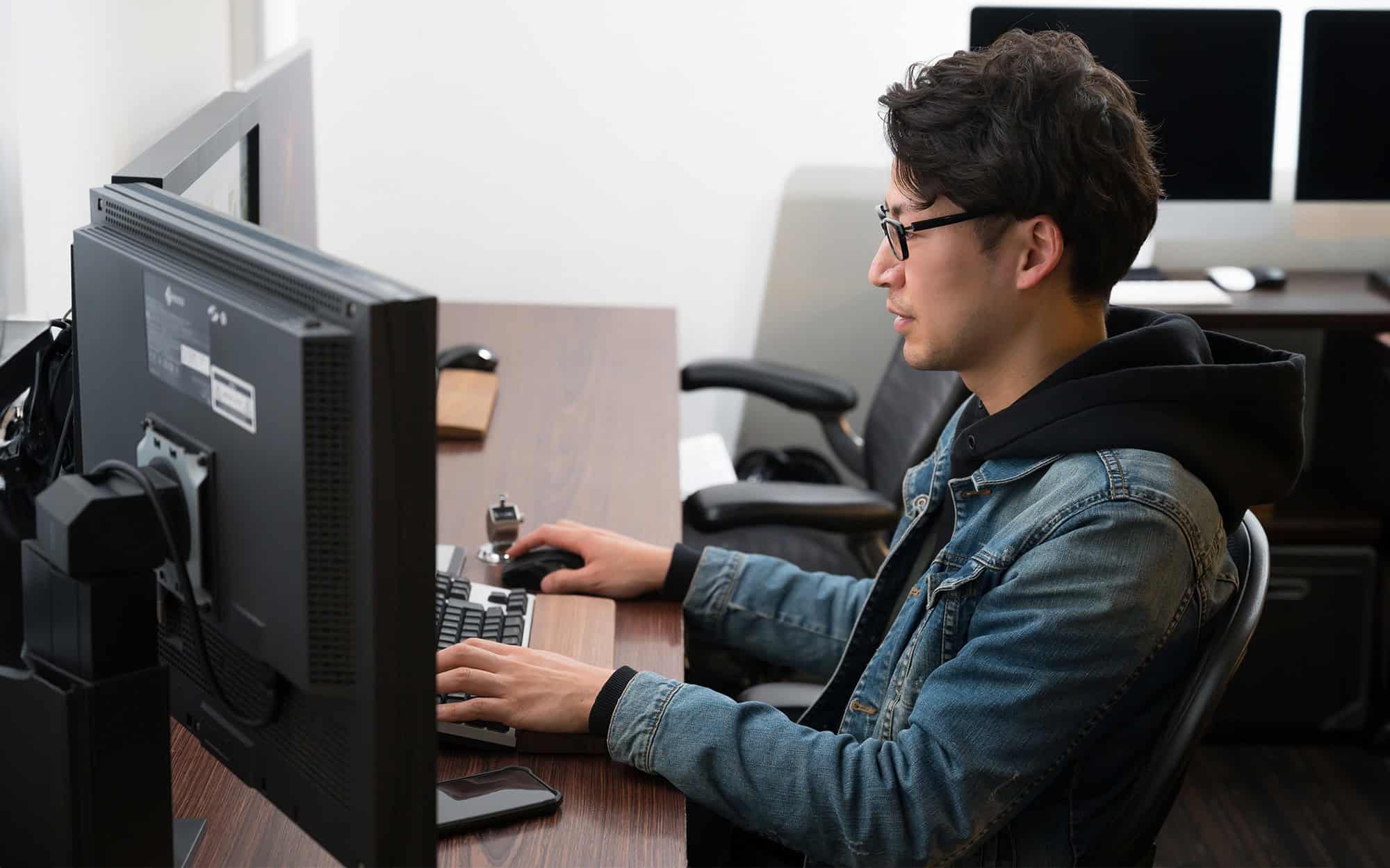 Side View Of Handsome Man Working On Computer
