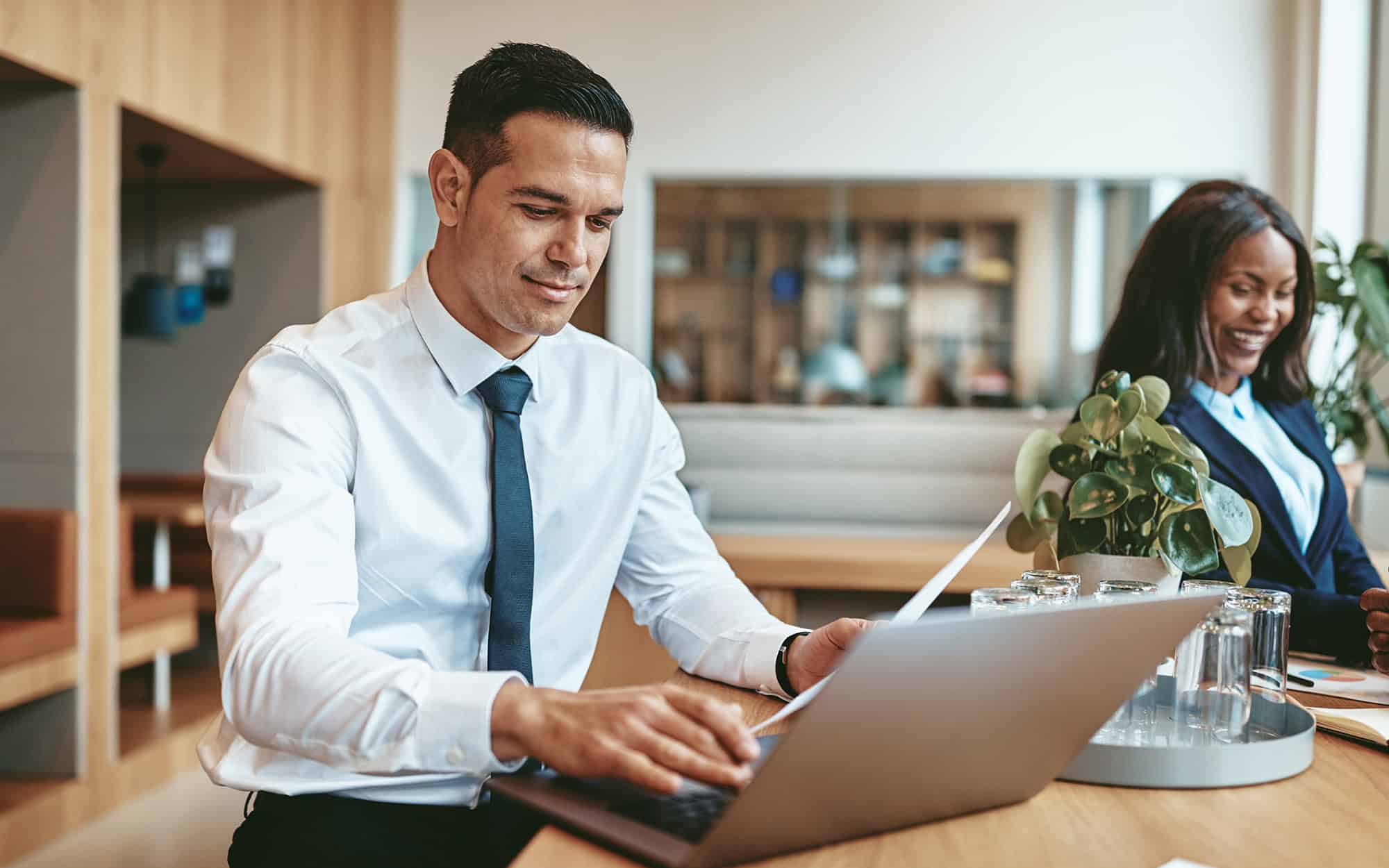 Solo Man Sitting In Cafe Doing Work On Laptop