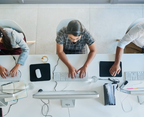 Call center, computer and top view with business people in office for communication