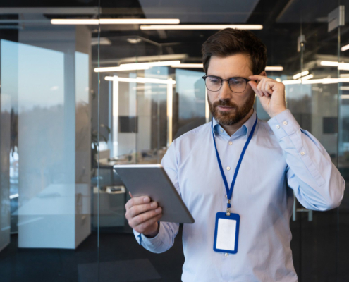 Front View Of Man Examining Smart Tablet