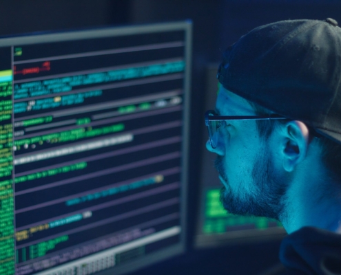 Hacker searching data for common cyberattack methods
