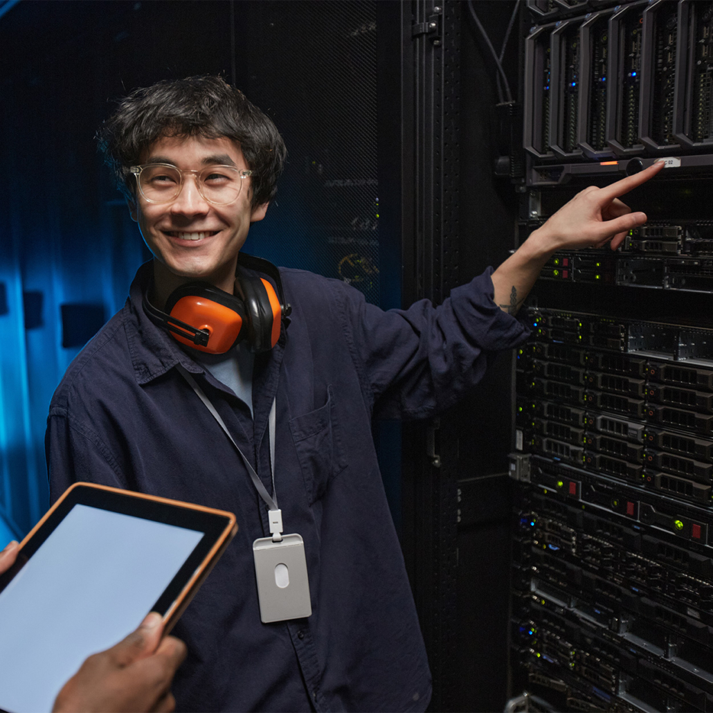 Header Smiling It Technicians Working Together In Server Room