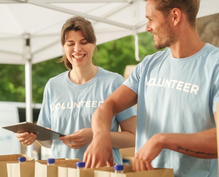 Two Charity Volunteers Organizing Food