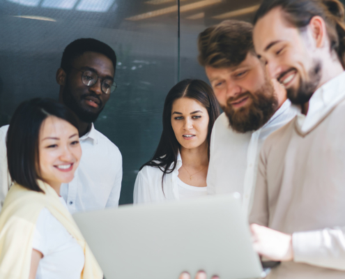 Team Of Smiling Multiracial Crew Of Skilled It Professionals Enjoying Cooperation