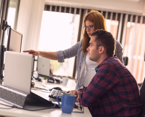 It Team Looking At Computer Monitor